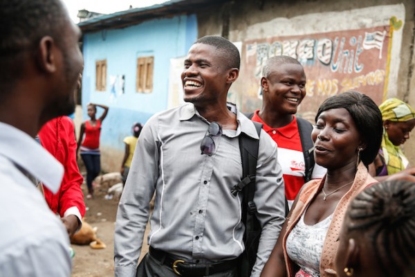 Yusuf Kabba (centre) talks with Ebola survivors in Freetown's Magazine Wharf—one of the city's largest slums where the disease hit families hard. Yusuf is President of the Sierra Leone Association of Ebola Survivors (SLAES). (Photo credit: Simon Davis/DFID)