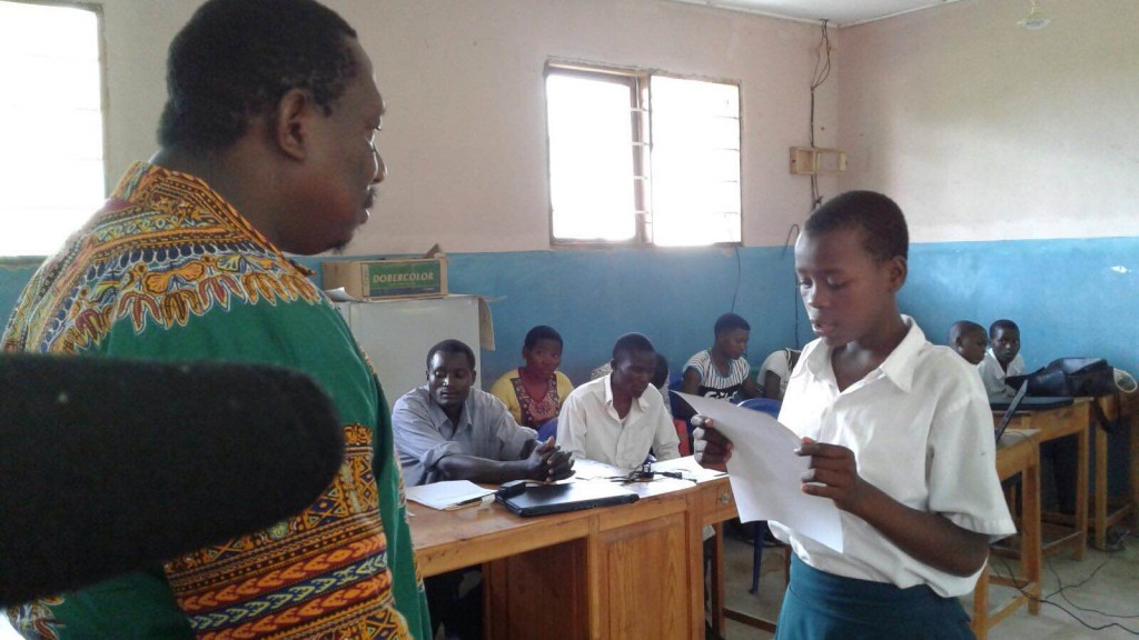 Eva Tolage, right, reads her letter to the Tanzanian government to her District Commissioner. (Photo credit: Restless Development)