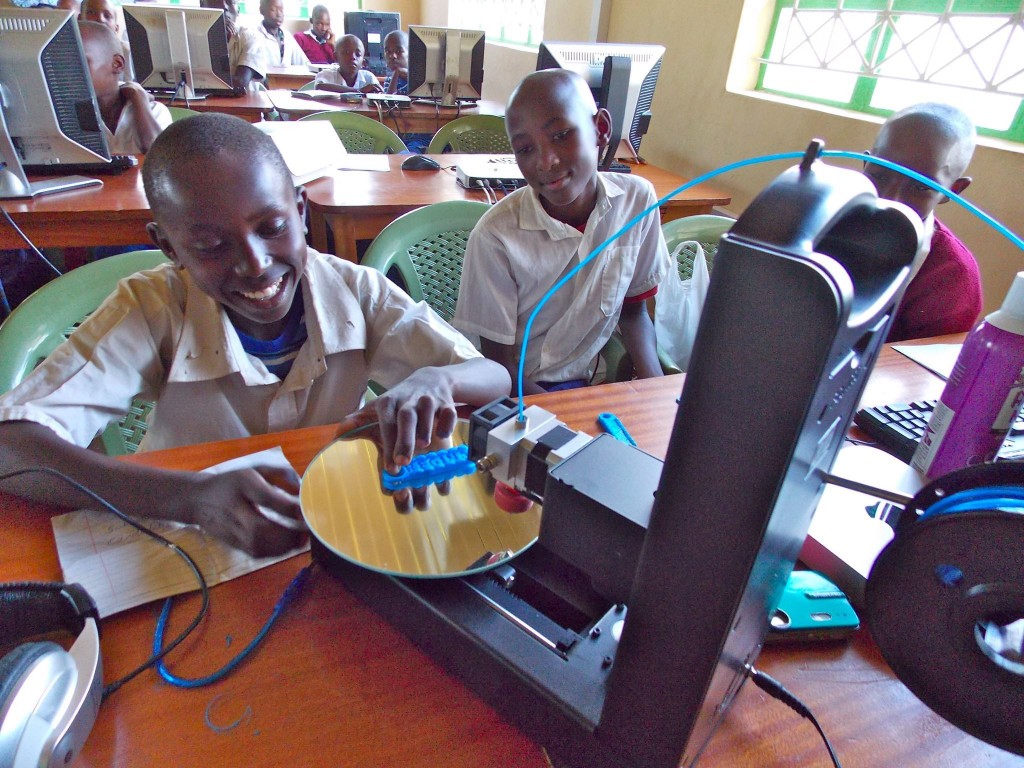 A student at Kenya Connect watches with delight as a project he designed emerges from the 3D printer. He and his classmates are participating in a global collaboration with students at New Canaan Country School through Level Up Village’s Global Inventors course.