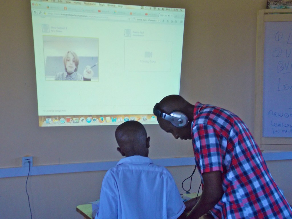 After watching a video message from his partner at New Canaan Country School, this student gets some pointers from Patrick Munguti of Kenya Connect. (Photo credit: Kenya Connect)